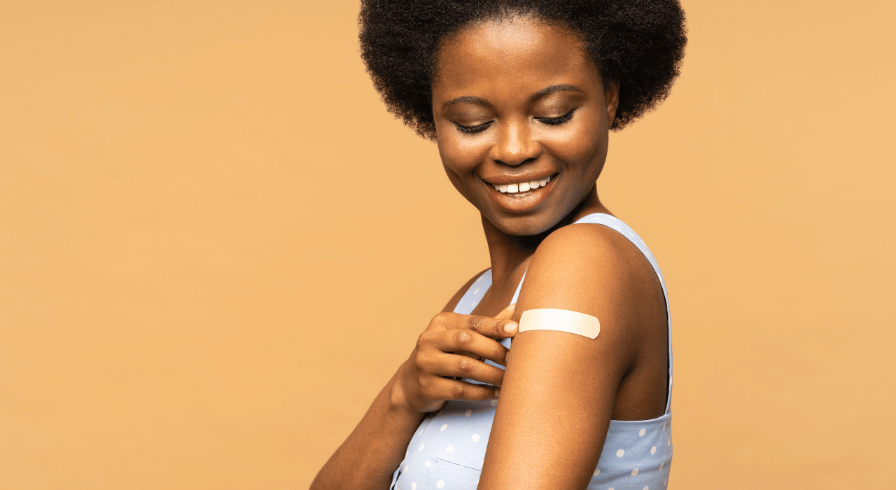 Woman with a Plaster on Her Arm After a Vaccination